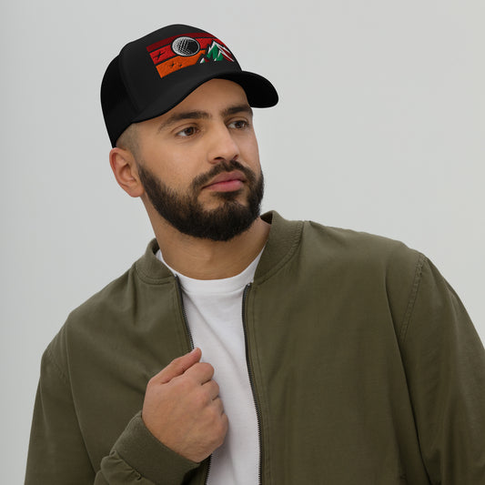 Male model wearing a black golf streetwear hat with a red sky, mountain and golf ball design on a plain background. Casual everyday golf streetwear cap by fourteefore for on and off the course