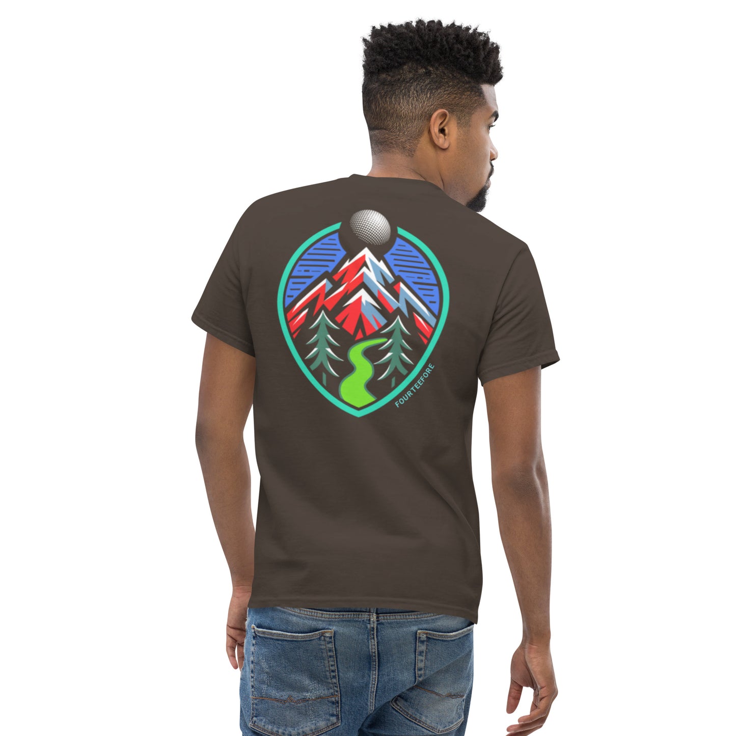 Rear view of male model wearing a brown Fourteefore tree lined fairway causal golf streetwear t-shirt with colorful bold mountain and tree lined fairway graphic on the back, small FTF logo embroidered on left chest. Casual everyday golf streetwear by fourteefore