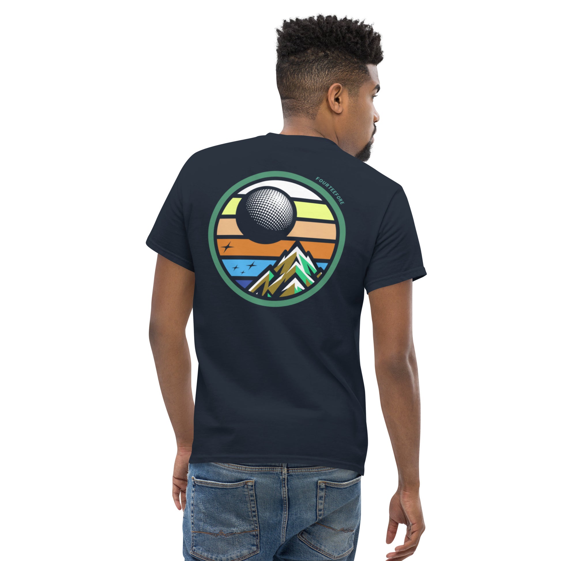 Male model wearing a Navy blue twilight golf Fourteefore casual golf streetwear t-shirt with a bold colorful graphic of a mountain, moon and stars at dusk on the back with a small FTF logo embroidered on the left chest